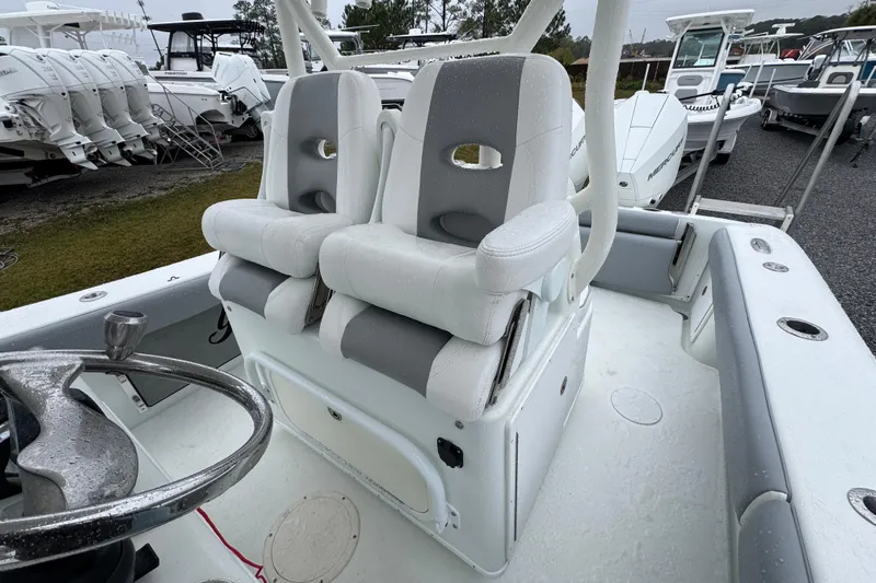  Yacht Photos Pics 2007 Yellowfin 31 Center Console boat with dual seats and steering wheel, parked outdoors.