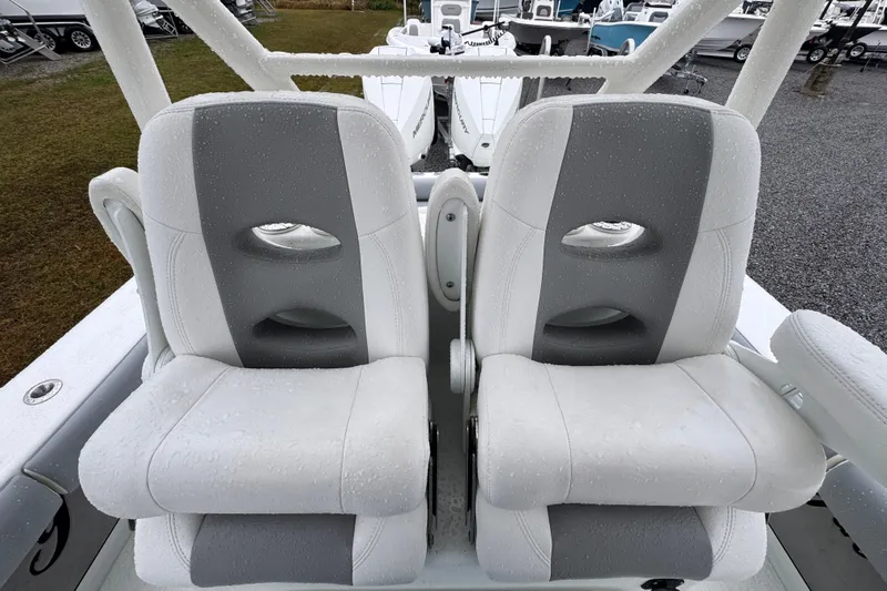  Yacht Photos Pics 2007 Yellowfin 31 Center Console boat seats with water droplets, showcasing comfort and style.