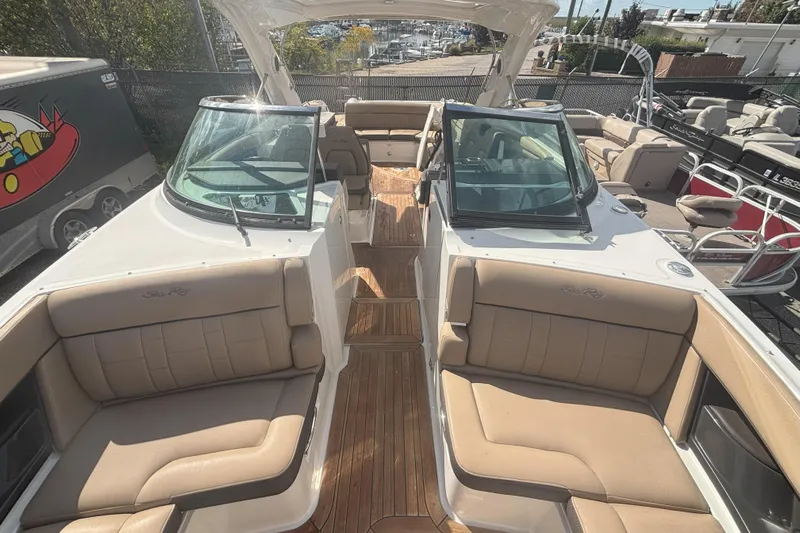  Yacht Photos Pics 2016 Sea Ray 350 SLX boat with tan seating and wooden deck, docked outdoors.