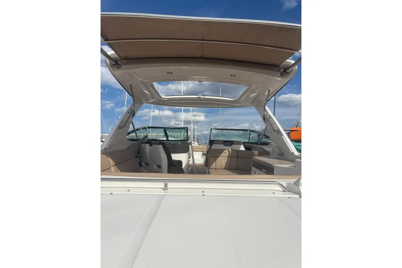  Yacht Photos Pics 2016 Sea Ray 350 SLX boat interior with open canopy under blue sky.