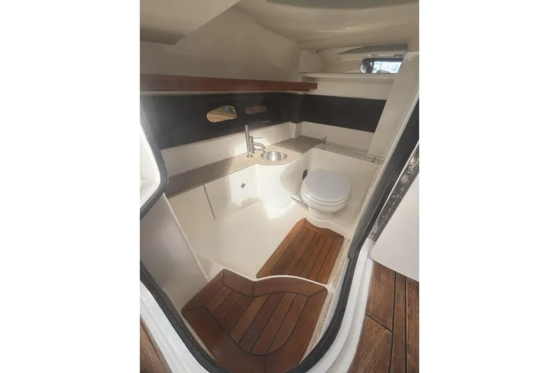  Yacht Photos Pics Luxurious 2016 Sea Ray 350 SLX boat bathroom with wooden flooring and modern fixtures.