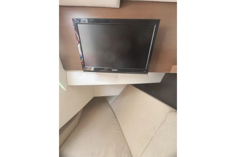  Yacht Photos Pics Interior of 2016 Sea Ray 350 SLX with wall-mounted TV and beige seating.