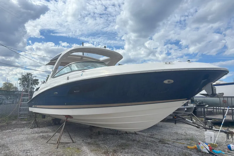  Yacht Photos Pics 2016 Sea Ray 350 SLX boat on dry dock under a cloudy sky.