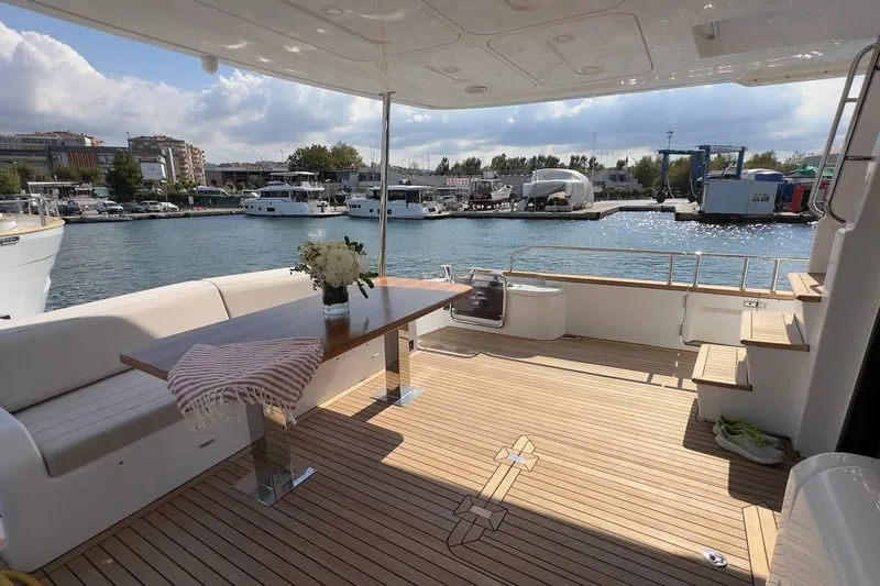  Yacht Photos Pics Luxurious 2024 Sirena 58 Fly yacht deck with elegant seating and waterfront view.