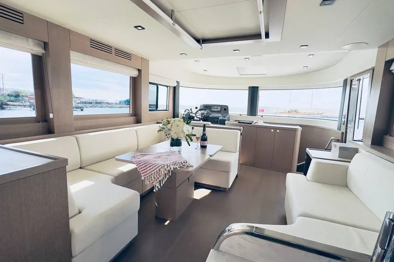 Yacht Photos Pics Luxurious interior of 2024 Sirena 58 Fly yacht with elegant seating and panoramic windows.