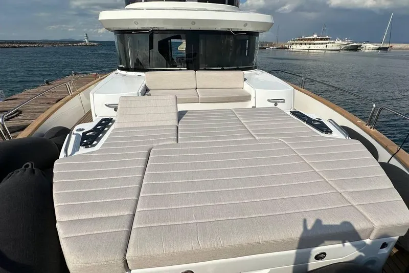  Yacht Photos Pics 2024 Sirena 58 Fly yacht with spacious sunbathing area, docked at marina.
