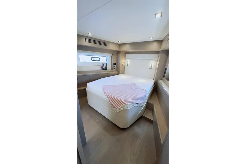  Yacht Photos Pics Luxurious bedroom interior of 2024 Sirena 58 Fly yacht with modern design and cozy bed.