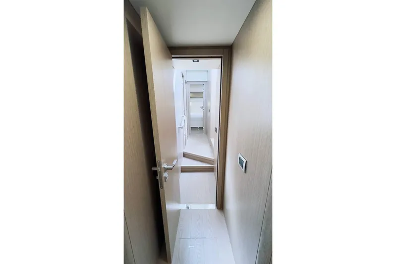  Yacht Photos Pics Interior hallway of 2024 Sirena 58 Fly yacht, featuring modern wood finishes.
