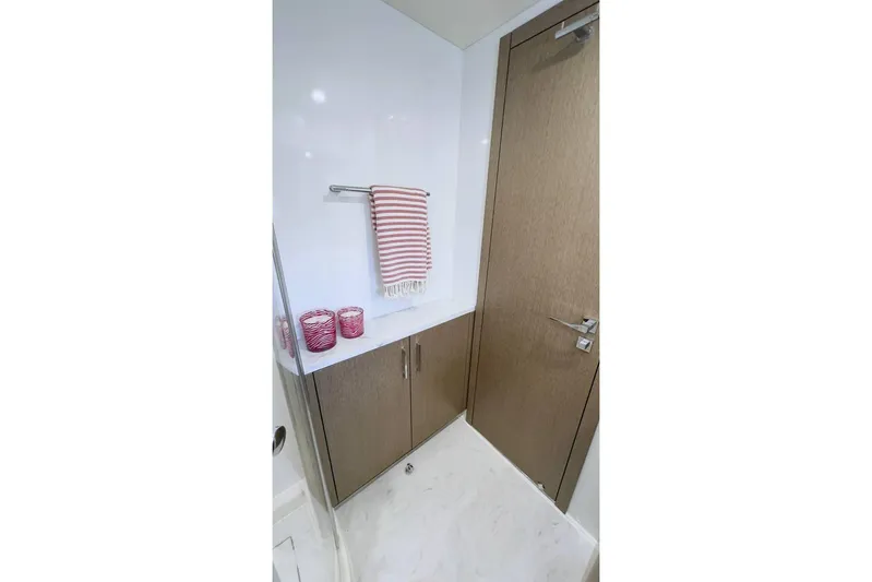  Yacht Photos Pics Modern bathroom interior on 2024 Sirena 58 Fly yacht, featuring wood accents and red decor.