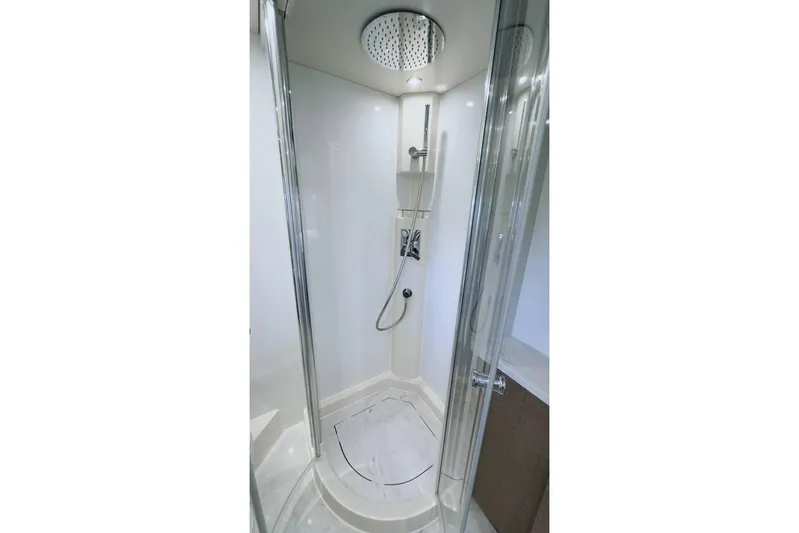  Yacht Photos Pics Modern shower in 2024 Sirena 58 Fly yacht, featuring sleek design and glass doors.