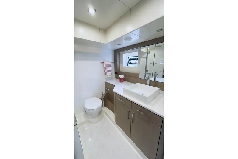  Yacht Photos Pics Luxurious bathroom in 2024 Sirena 58 Fly yacht, featuring modern fixtures and elegant design.