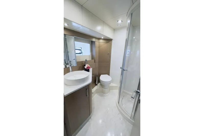  Yacht Photos Pics Luxurious bathroom in 2024 Sirena 58 Fly yacht with modern fixtures and elegant design.
