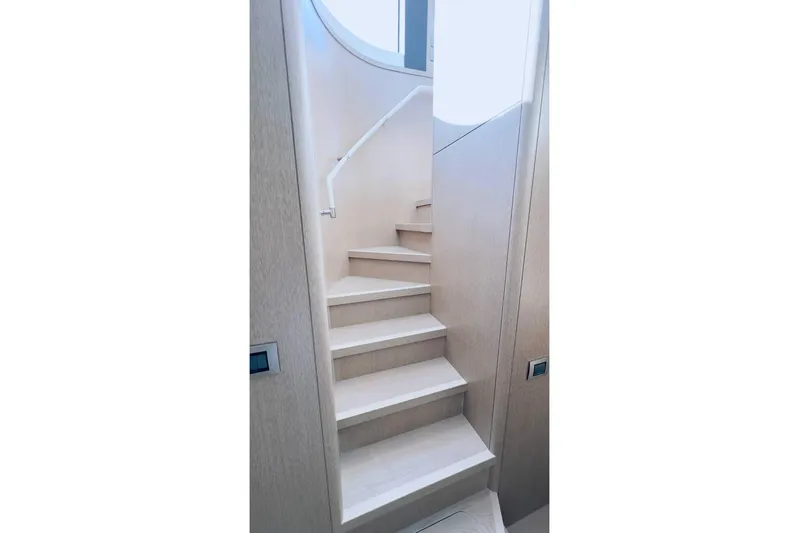  Yacht Photos Pics Staircase inside 2024 Sirena 58 Fly yacht, featuring modern design and light wood finish.