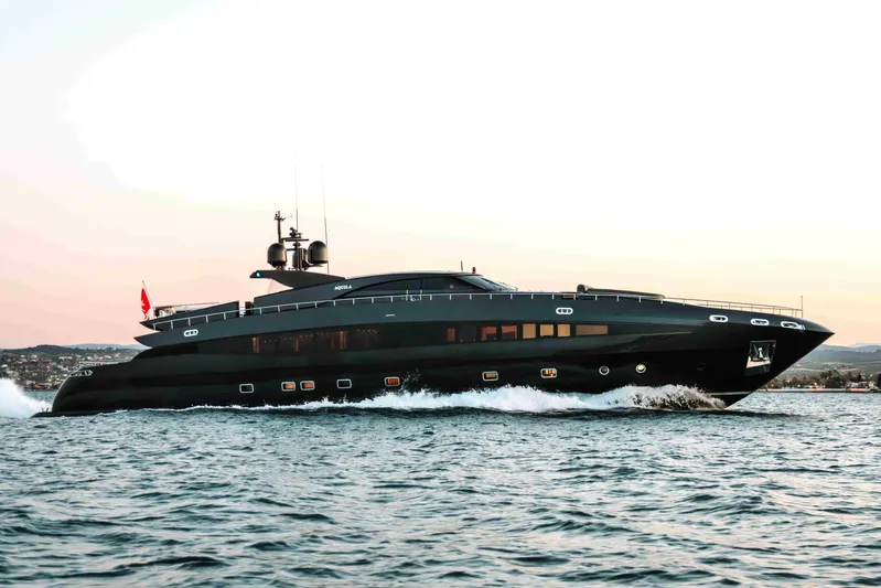 Aquila Yacht Photos Pics Luxurious 2004 Baglietto Custom yacht cruising at sunset on open water.