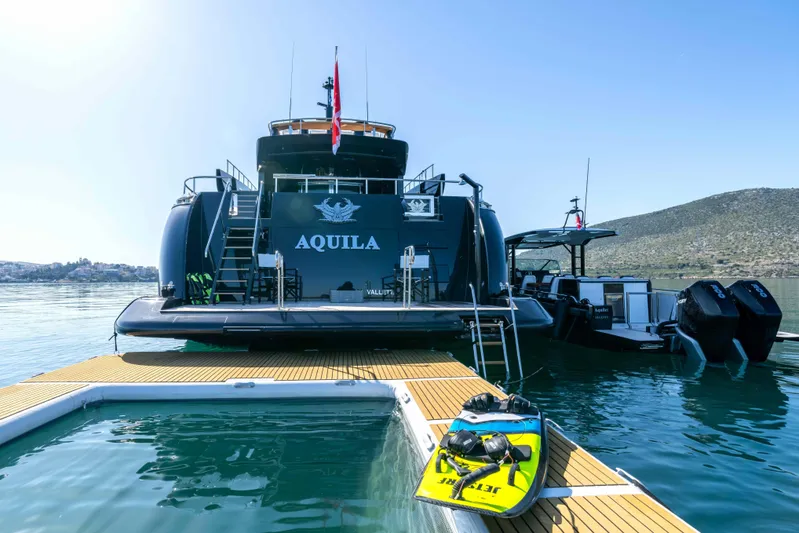 Aquila Yacht Photos Pics Luxury yacht "Aquila" by Baglietto, 2004 model, docked with water sports equipment.