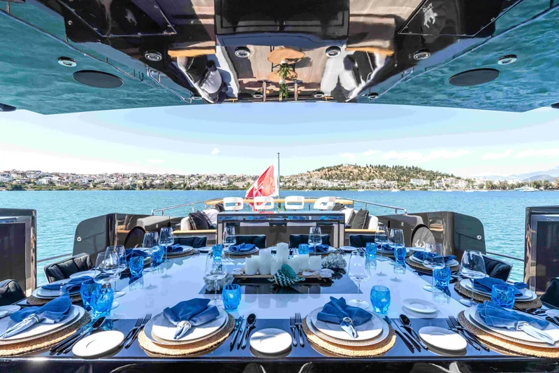 Aquila Yacht Photos Pics Luxurious dining setup on a 2004 Baglietto Custom yacht, overlooking serene waters.