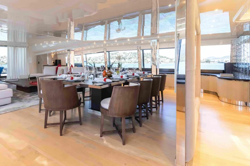 Aquila Yacht Photos Pics Luxurious dining area on a 2004 Baglietto Custom yacht with elegant furnishings and scenic views.