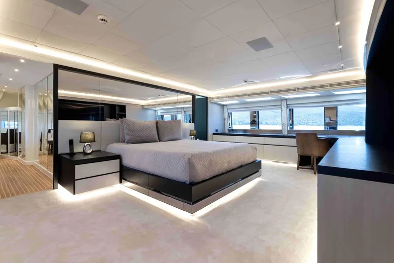 Aquila Yacht Photos Pics Luxurious bedroom interior on a 2004 Baglietto Custom yacht, featuring modern design and ambient lighting.