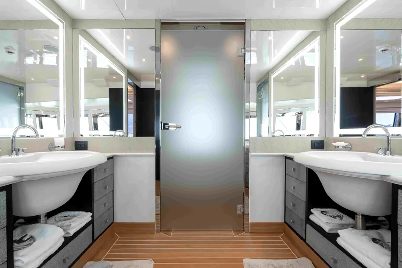 Aquila Yacht Photos Pics Luxurious yacht bathroom with dual sinks, modern mirrors, and elegant design on a 2004 Baglietto Custom.
