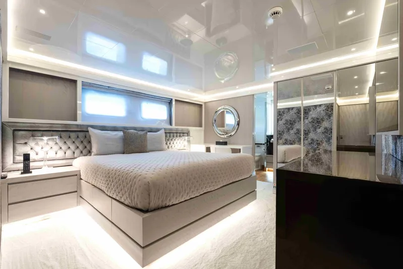 Aquila Yacht Photos Pics Luxurious bedroom interior on a 2004 Baglietto Custom yacht, featuring modern design and ambient lighting.