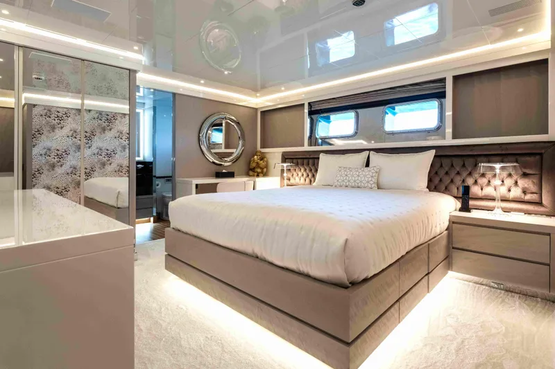 Aquila Yacht Photos Pics Luxurious bedroom interior on 2004 Baglietto Custom yacht, featuring elegant decor and ambient lighting.