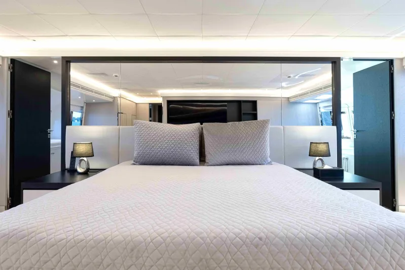 Aquila Yacht Photos Pics Luxurious bedroom interior on 2004 Baglietto Custom yacht, featuring elegant bedding and modern lighting.