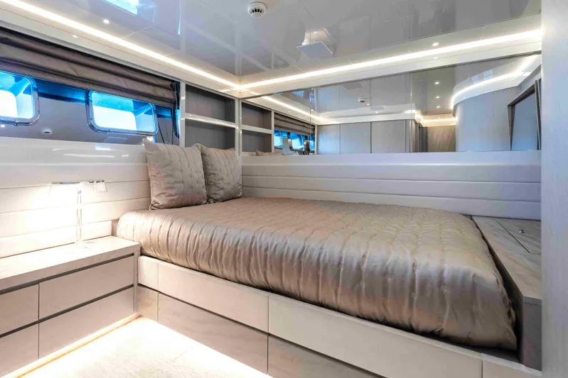 Aquila Yacht Photos Pics Luxurious bedroom interior on a 2004 Baglietto Custom yacht, featuring modern design and ambient lighting.