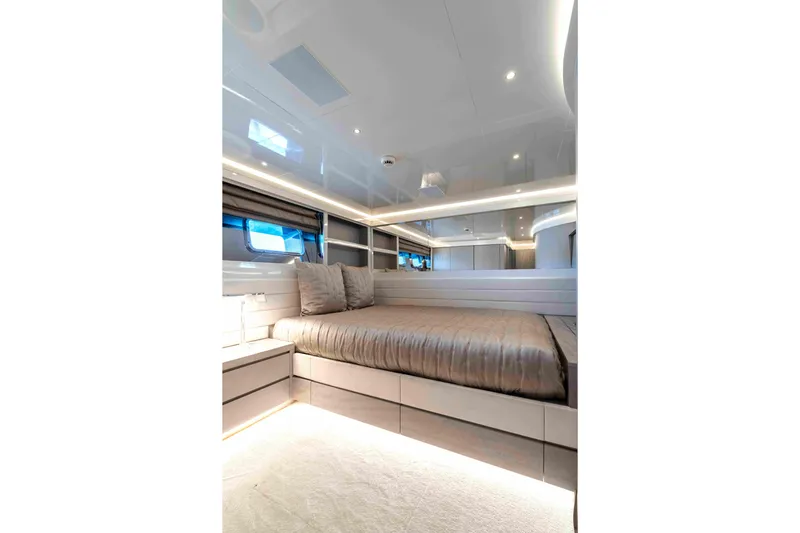Aquila Yacht Photos Pics Luxurious bedroom interior on 2004 Baglietto Custom yacht, featuring modern design and ambient lighting.