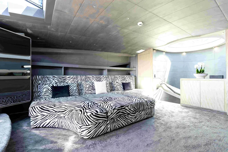Aquila Yacht Photos Pics Luxurious yacht interior with zebra-patterned sofa, modern decor, and skylight. Baglietto Custom 2004.