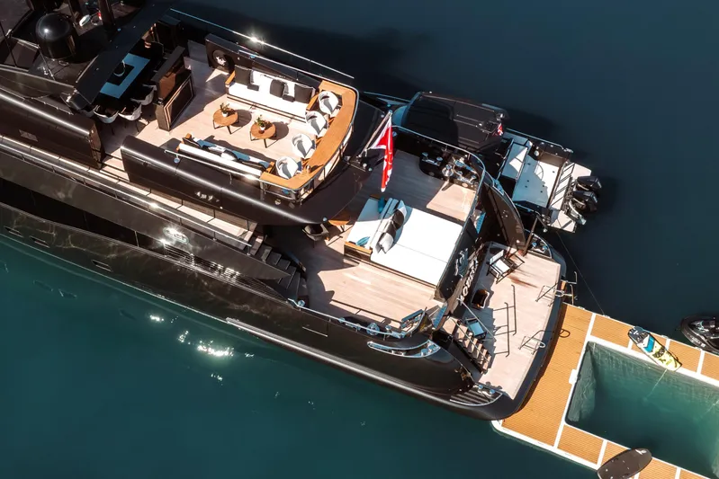 Aquila Yacht Photos Pics Luxurious 2004 Baglietto Custom yacht with elegant deck and modern amenities, docked on serene water.