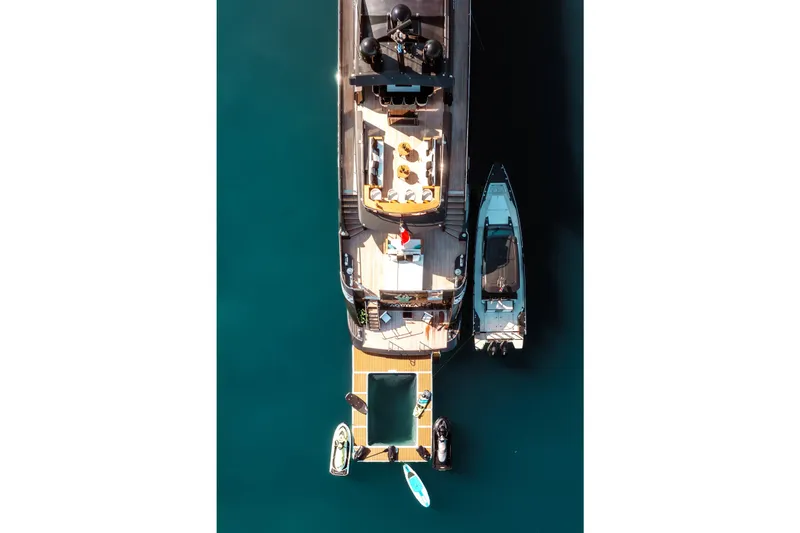 Aquila Yacht Photos Pics Aerial view of 2004 Baglietto Custom yacht with docked boats and paddleboards.