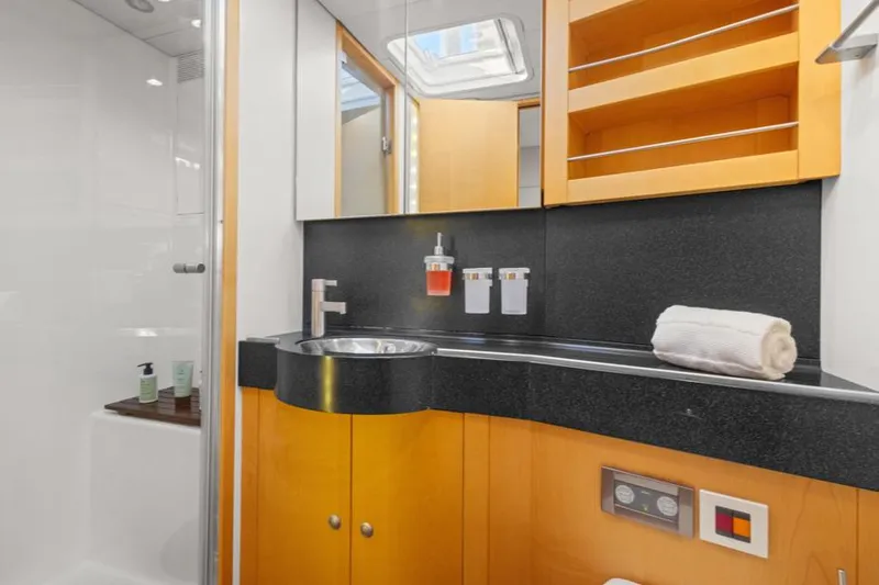 Valkyrie Yacht Photos Pics Luxurious bathroom in 2007 Nautor Swan Tripp 78 yacht with modern fixtures and wooden cabinetry.