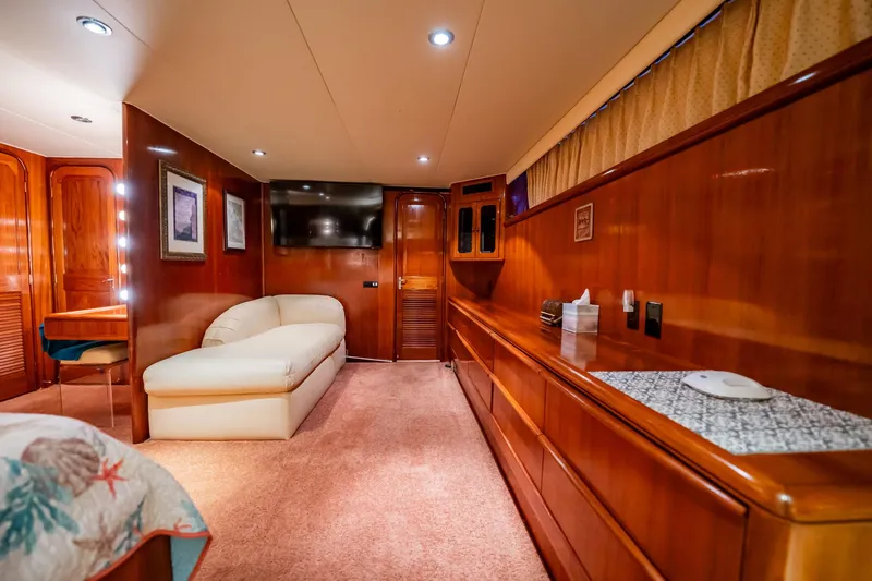 Jubilee Yacht Photos Pics Luxurious interior of 1989 Viking 63 Motor Yacht with wood paneling and plush seating.