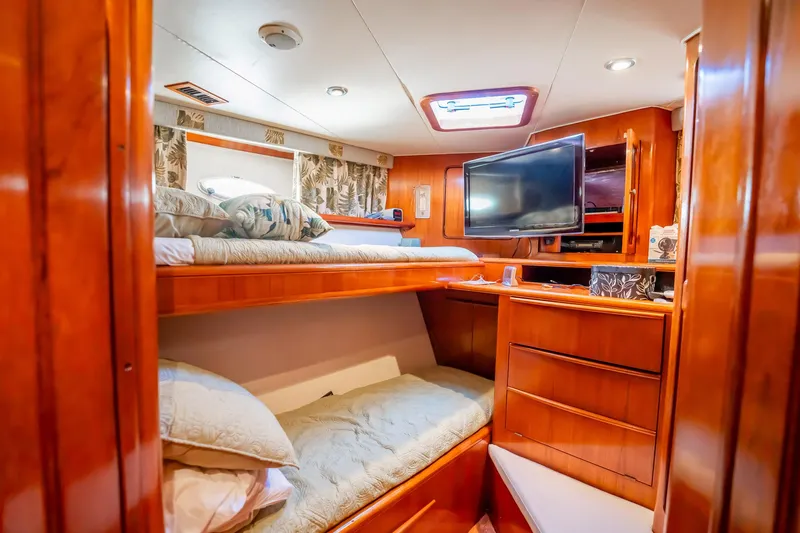Jubilee Yacht Photos Pics Luxurious cabin interior of 1989 Viking 63 Motor Yacht with bunk beds and TV.