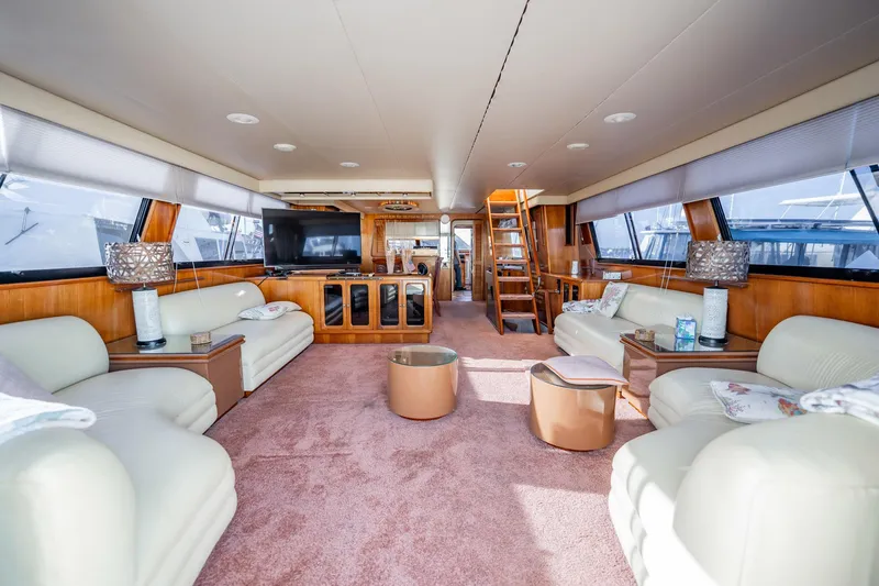 Jubilee Yacht Photos Pics Luxurious interior of 1989 Viking 63 Motor Yacht with plush seating and elegant decor.