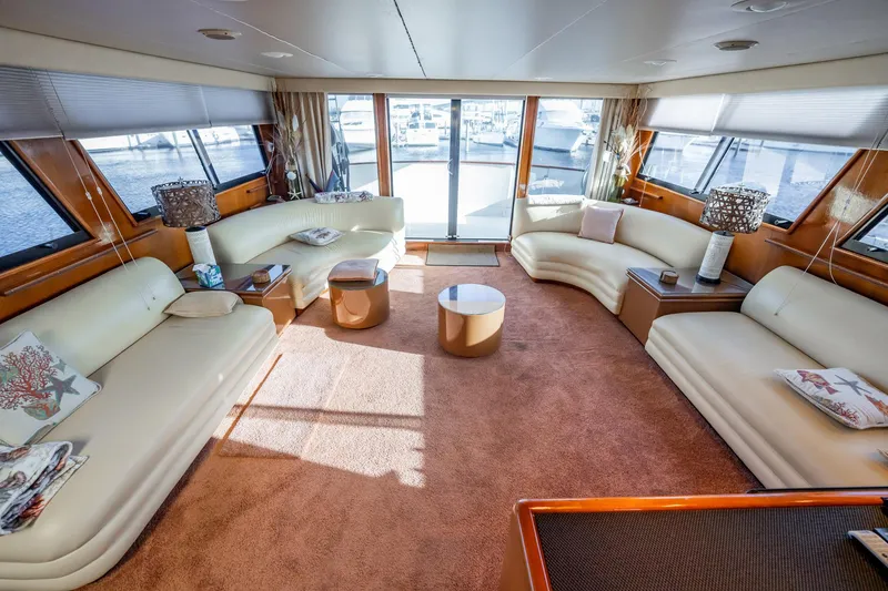 Jubilee Yacht Photos Pics Luxurious interior of 1989 Viking 63 Motor Yacht with elegant seating and panoramic windows.
