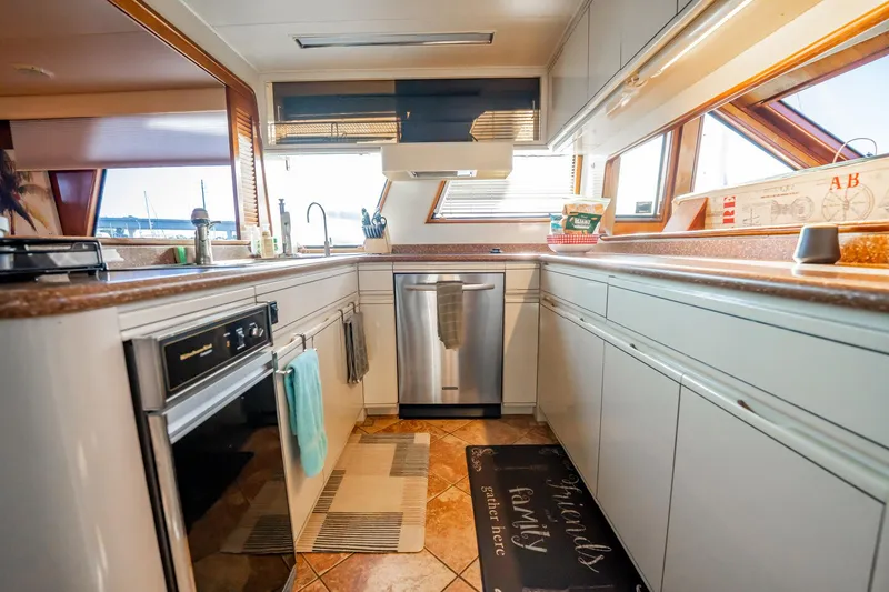 Jubilee Yacht Photos Pics Spacious kitchen in 1989 Viking 63 Motor Yacht with modern appliances and ample counter space.
