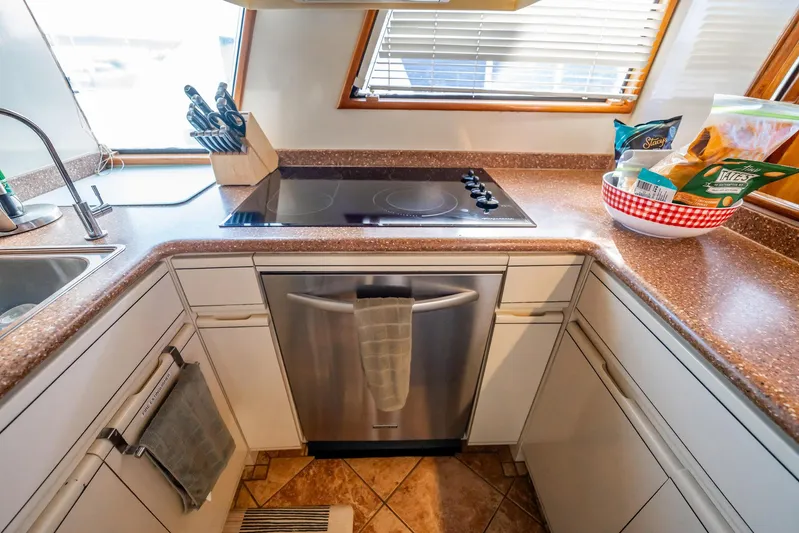 Jubilee Yacht Photos Pics Kitchen area of a 1989 Viking 63 Motor Yacht with modern appliances and countertop.