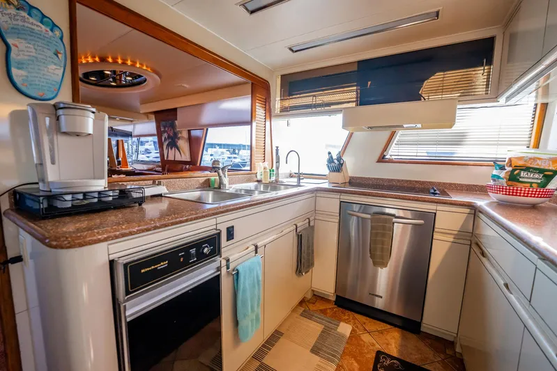 Jubilee Yacht Photos Pics Luxurious kitchen interior of 1989 Viking 63 Motor Yacht with modern appliances and ample counter space.