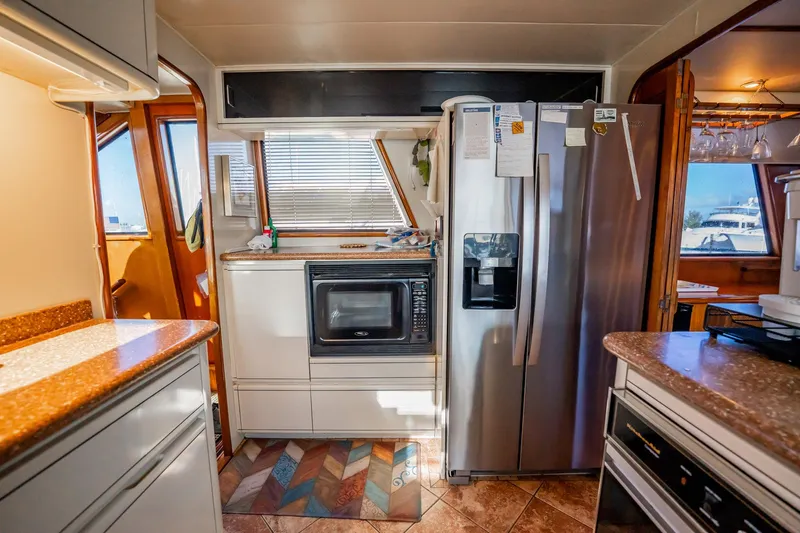 Jubilee Yacht Photos Pics Kitchen interior of a 1989 Viking 63 Motor Yacht with modern appliances.