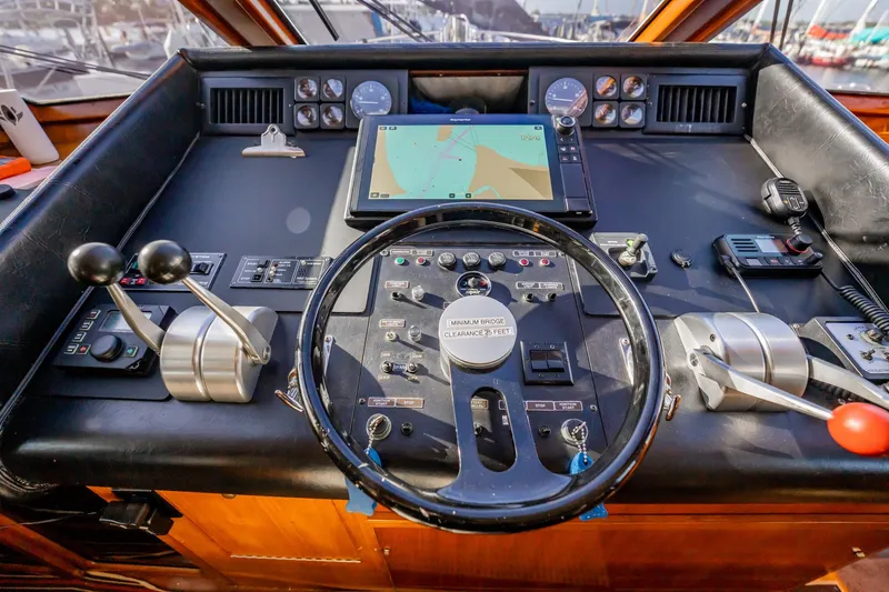 Jubilee Yacht Photos Pics Cockpit of 1989 Viking 63 Motor Yacht with navigation controls and steering wheel.