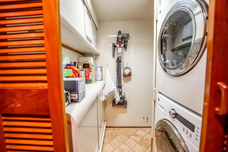 Jubilee Yacht Photos Pics Laundry area on 1989 Viking 63 Motor Yacht with stacked washer and dryer.
