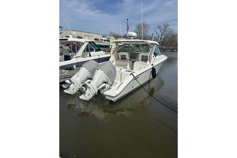  Yacht Photos Pics 2024 Pursuit DC 326 Dual Console boat docked with twin outboard engines.