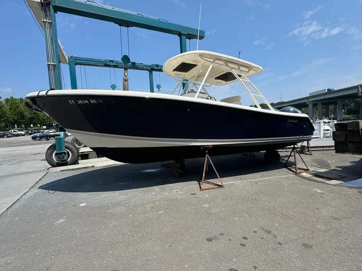  Yacht Photos Pics 2014 Pursuit S 280 Sport boat on stands at a marina.