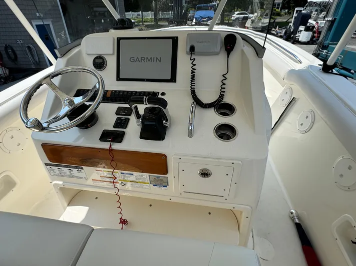  Yacht Photos Pics 2014 Pursuit S 280 Sport boat dashboard with Garmin navigation system and controls.