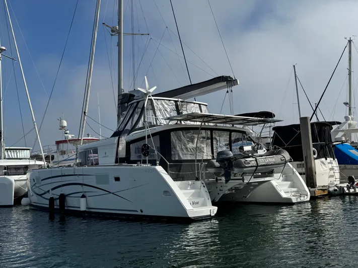 La Vigie Yacht Photos Pics 2018 Lagoon 450 F catamaran docked in a marina, featuring sleek design and modern amenities.