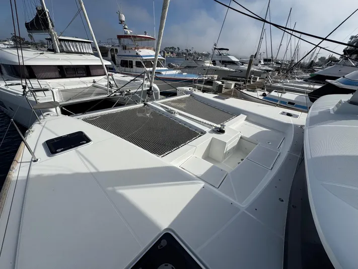 La Vigie Yacht Photos Pics 2018 Lagoon 450 F catamaran docked in a marina, surrounded by other boats.