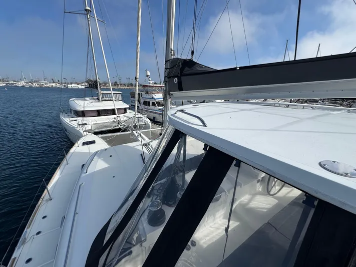 La Vigie Yacht Photos Pics 2018 Lagoon 450 F catamaran docked in a marina, with clear blue skies.