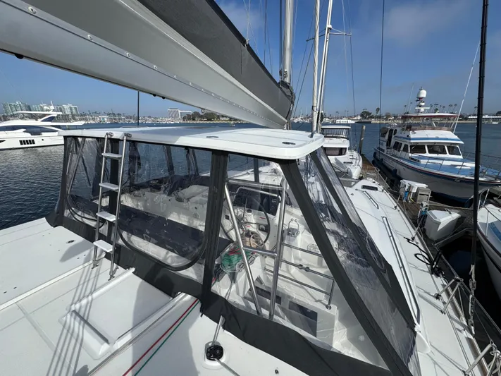 La Vigie Yacht Photos Pics 2018 Lagoon 450 F catamaran docked at marina, featuring spacious deck and enclosed cockpit.