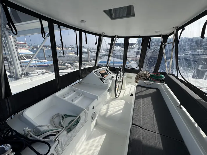 La Vigie Yacht Photos Pics Interior view of 2018 Lagoon 450 F catamaran cockpit with marina background.